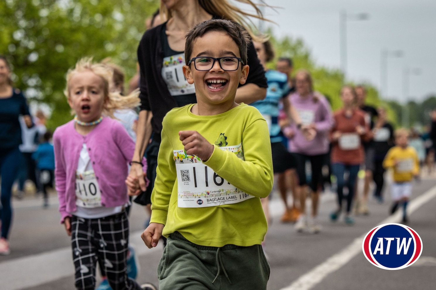 A boy smiles as he runs